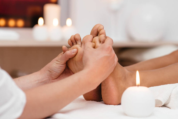 Perfect clean female foot . Beautiful and elegant groomed girl's hand touches her feet . Spa ,scrub and leg care . - Foto, Imagen