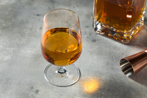 Boozy Whiskey in a Snifter Glass Ready to Drink - Fotoğraf, Görsel