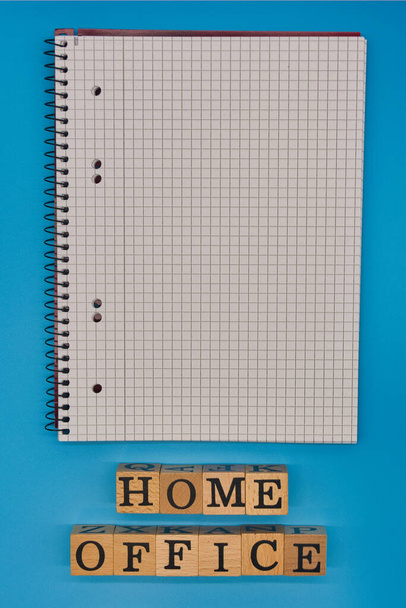 blank notebook with letters on a blue background - Zdjęcie, obraz