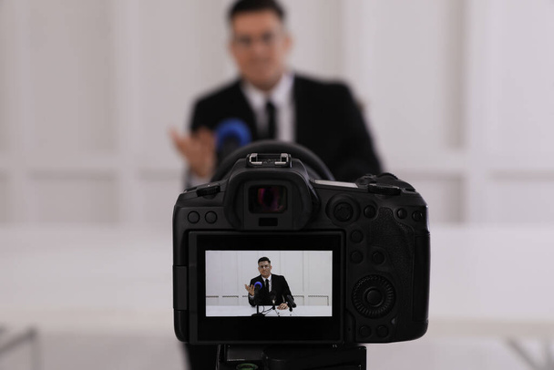 Business man giving interview at official event, focus on video camera screen - Foto, Imagen