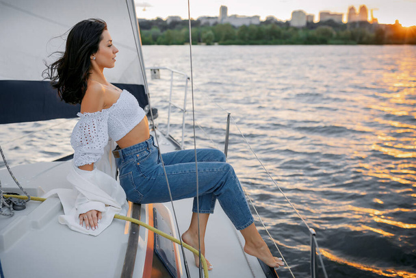 Bachelorette party on a yacht, a beautiful girl on a walk along the river. setting sun - Foto, imagen