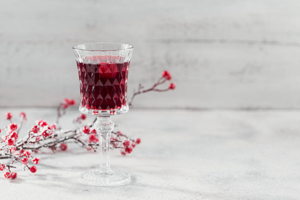 Glass of cherry liqueur oe wine on white background. Christmas or new year party celebration concept. Winter holidays concept. - Φωτογραφία, εικόνα