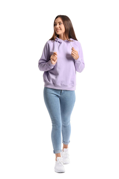 Beautiful young woman in stylish hoodie on white background - Fotó, kép