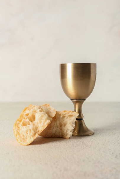 Cup of wine with bread on light background - Photo, Image