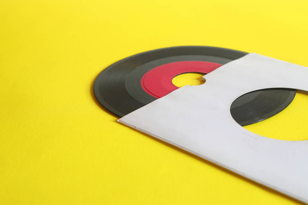 45rpm Vinyl Record with Sleeve. close up vinyl on yellow background.  - Photo, Image