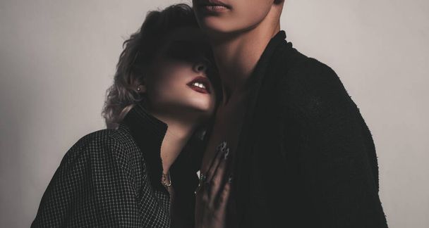 Affectionate couple having a fun while a photo session. Young heterosexual couple embracing. Close up photo. Portrait of happy loving couple. Handsome guy is hugging pretty girl with short hair. - 写真・画像