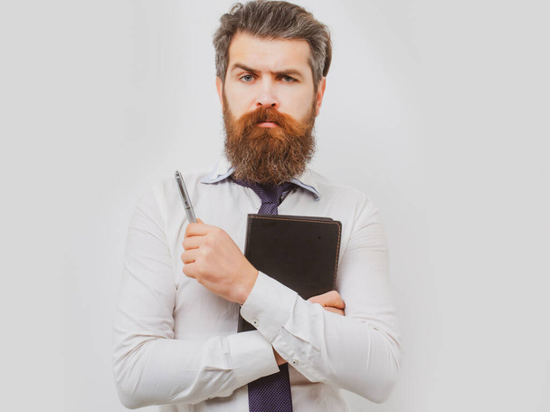 Business man is thinking about something with pencil. Business dreams. Thoughtful young man in shirt and tie holding note pad and pen. - Photo, Image