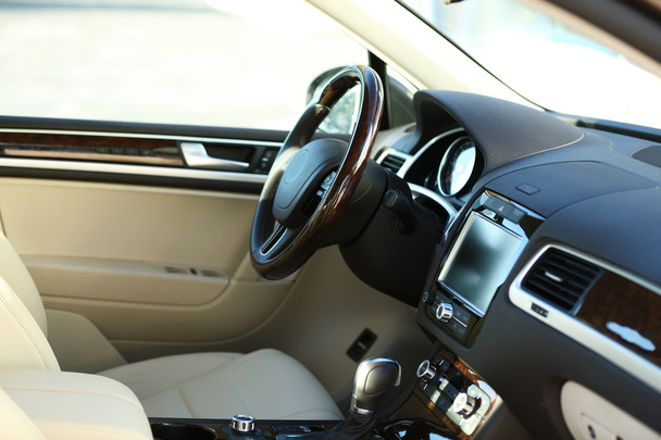Interior view of car with beige salon and black dashboard - Фото, зображення