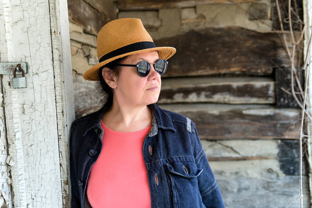 Portrait of an adult woman in a hat and sunglasses, . Fashionable and stylish woman. Street style. - Fotografie, Obrázek