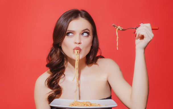 Italian woman eats Bolognese pasta. Woman cooked spaghetti. Italia food and menu concept. Woman suck spaghetti. - Photo, Image