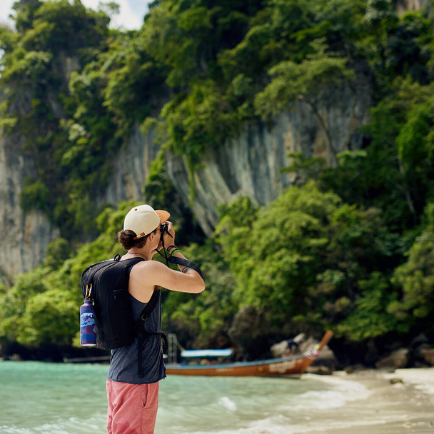 Capturing the beauty of nature. Cropped shot of a young tourist taking photos while on vacation. - 写真・画像