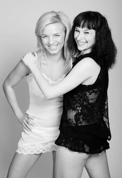 Blonde and brunette women in slips embrace - Fotografie, Obrázek
