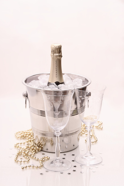 Champagne bottle in cooler, two champagne glasses - Foto, Imagen