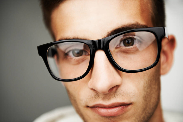 Looking into the eyes of a Hipster. Portrait close up of a man with hipster glasses on. - Photo, Image