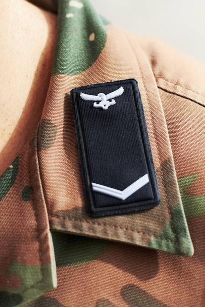 We have a proud military history. Closeup shot of a battalion insignia on a shoulders lapel. - Photo, Image