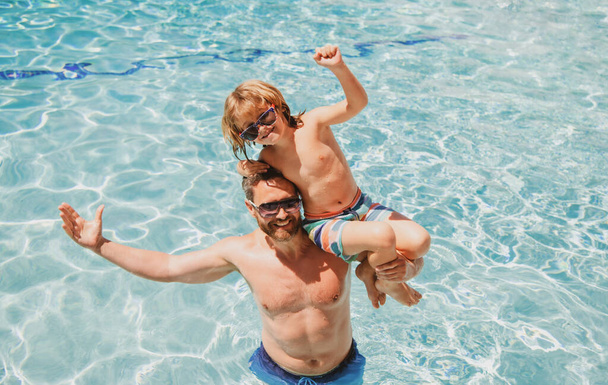 Father and son on summer weekend. Child with dad playing in swimming pool. Pool party. Sport activity. - Photo, Image