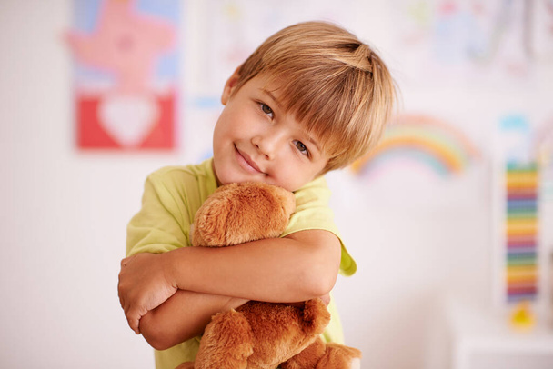 Childhood moments. Portrait of a cute little boy hugging his stuffed animal. - Photo, Image