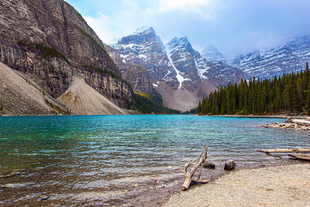 Picturesque and magnificent mountain lake Moraine. Canadian Rockies. Banff Park. The glacial lake is fed by glacier melt water and is located in the Valley of the Ten Peaks - Фото, изображение