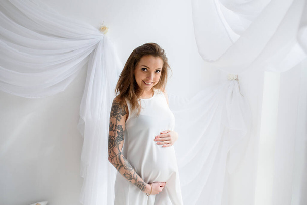 Beautiful pregnant girl with tattoo - Фото, изображение