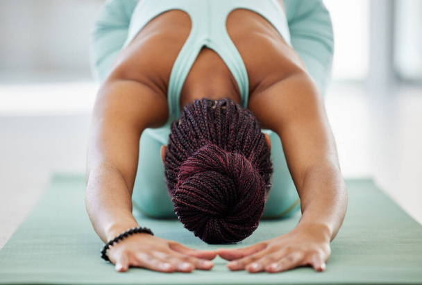 Estirar los hombros. Fotografía de una mujer irreconocible practicando yoga en el estudio y sosteniendo una pose infantil. - Foto, imagen