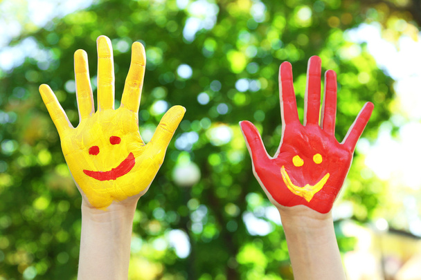 Smiling colorful hands on natural background - Fotoğraf, Görsel