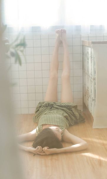 young woman lying on bed and looking at camera - Valokuva, kuva
