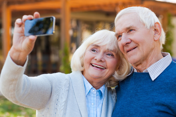 Happy senior couple making selfie - 写真・画像