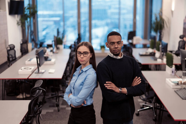 Two happy diverse professional executive business team people woman and African American man looking at camera standing in office lobby hall. Multicultural company managers team portrait. - Фото, изображение