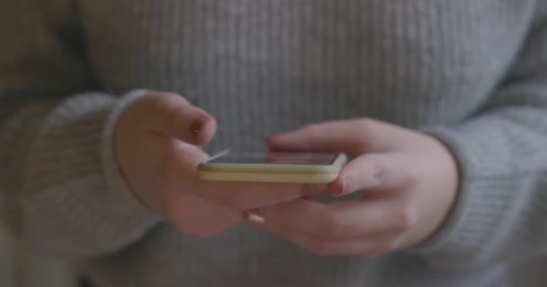 Close up of a young woman with smartphone, happy girl using mobile phone standing up. Concept of online addiction, social media, sms messages, sex dating, internet - Footage, Video