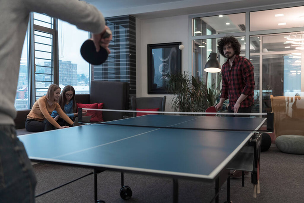 Two young start up business man playing ping pong tennis at modern creative office space people group have meeting and brainstorming in background - Fotografie, Obrázek