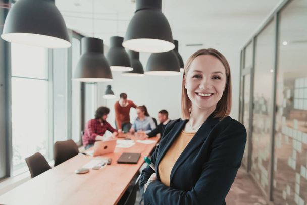 Portrait of happy businesswoman owner in modern office. Businesswoman smiling and looking at camera. Busy diverse team working in background. Leadership concept. Head shot. - Valokuva, kuva