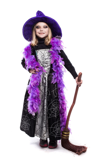 Beautiful cute little girl in witch halloween costume hold the broom - Фото, зображення