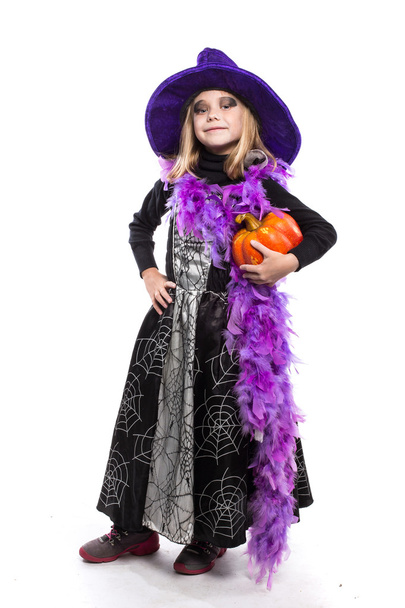 Cute little Halloween witch holding a orange pumpkin - Фото, зображення