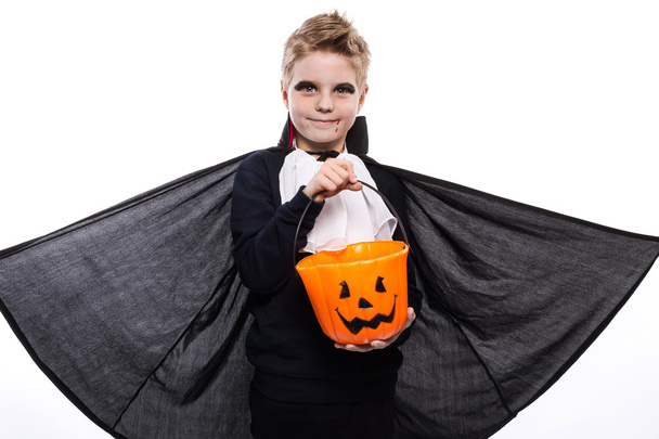Boy with pumpkin basket dressed like vampire for Halloween party - Photo, Image