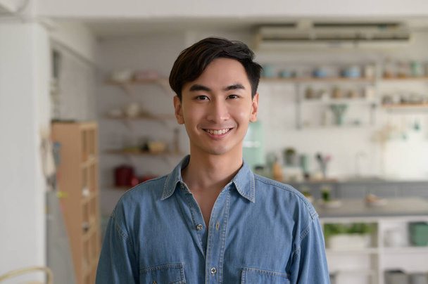 Portrait of young asian man in the living room at home - Photo, image