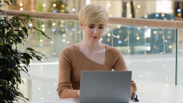 Close-up portrait 40s blonde middle aged business woman nice cheerful glad happy lady financier start-up owner manager worker with laptop showing ok sign advice fine great cool agree symbol in office - Footage, Video