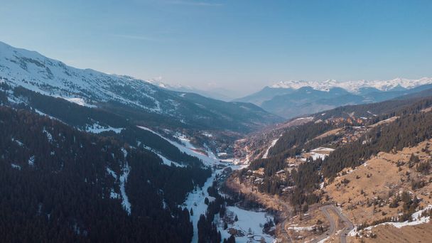 Aerial panorama of Meribel village, on the end of the valley in the french Alps. Beautiful panorama of ski slopes and chalets with alpine background. - Φωτογραφία, εικόνα