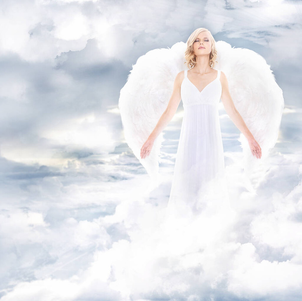 Divine goddess. A beautiful angel on clouds. - Фото, изображение