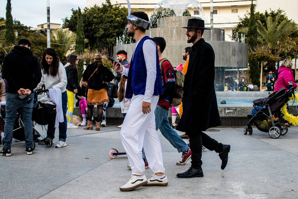 Tel Aviv, Israel - March 18, 2022 Israeli people at Dizengoff square dressed with costumes for the Purim carnival celebration which takes place on March in Israel, Purim festival is a Jewish tradition - 写真・画像