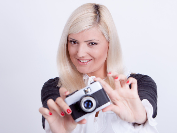 Blonde woman photographing over white background  - Photo, Image