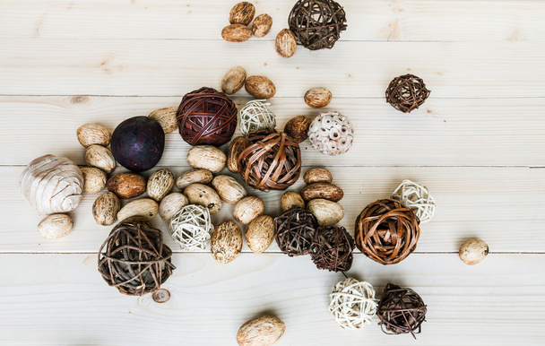 Brown rattan balls on old wooden background - 写真・画像