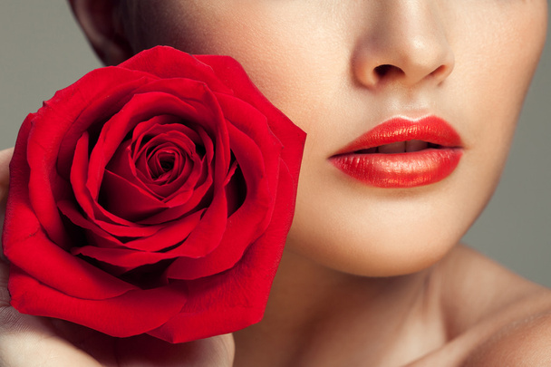 Young beauty model with red rose near lips - Φωτογραφία, εικόνα