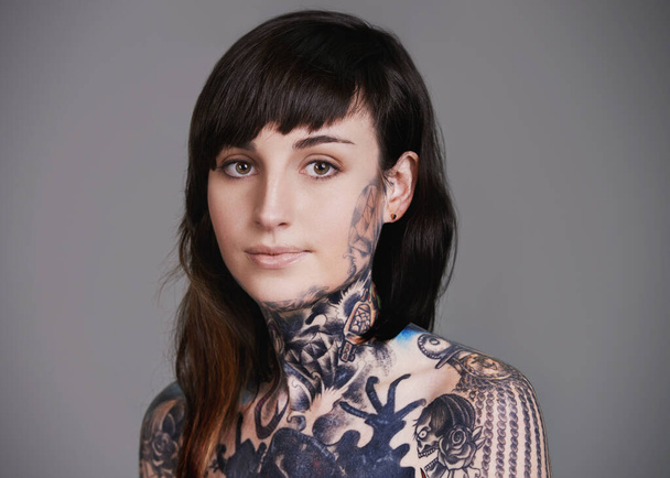Artistic attire. A cropped studio portrait of a tattooed young woman. - Photo, Image