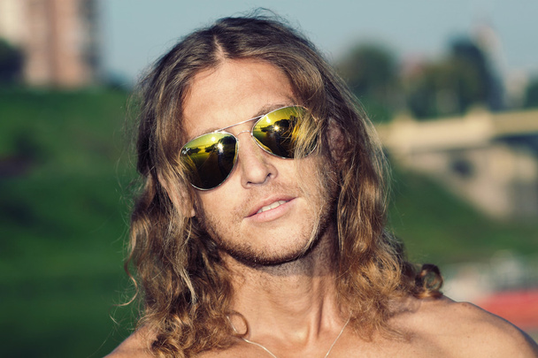 Courageous unshaven man with long hair - Foto, afbeelding