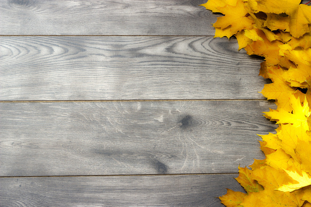 Golden maple leaves on a wooden background - Fotografie, Obrázek