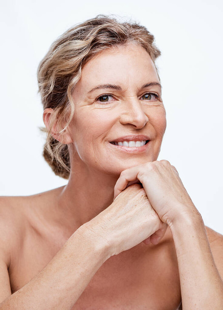 No one regrets a good skincare regime. Shot of a beautiful mature woman posing against a white background. - 写真・画像