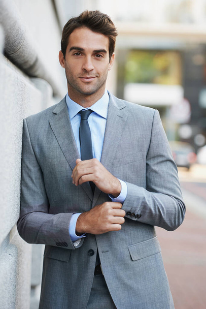 Working in the city. A handsome young businessman looking at the camera. - Photo, Image