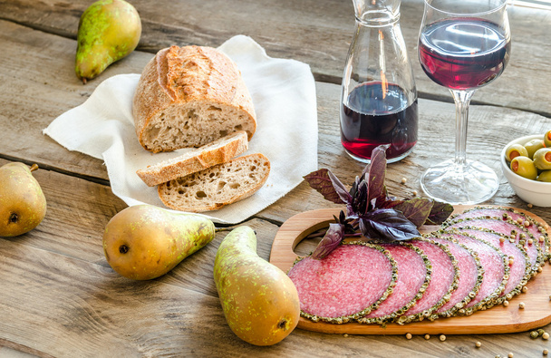 Slices of italian salami with pears and wine - Photo, Image
