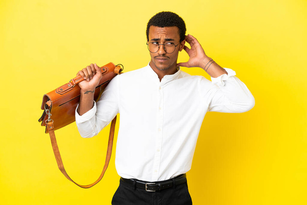 African American business man over isolated yellow background having doubts - Fotó, kép