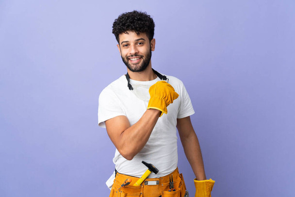 Young electrician Moroccan man isolated on purple background celebrating a victory - Photo, Image